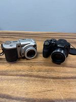 Front view of both Fujifilm cameras on tabletop