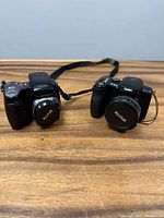 Two Kodak cameras top view with lens caps attached