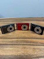 Front view of three Polaroid cameras showing colours and lens bezels