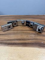 Front view of five Kodak cameras arranged in semicircle