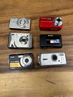 Front view of five damaged digital cameras