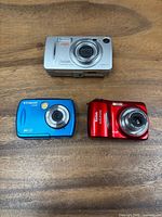 Front view of all three cameras showing brand names, colors and lens condition