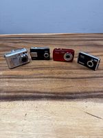 Front view of four Vivitar cameras on tabletop