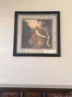Full view of first framed angel print on wall