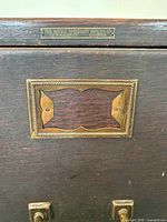 brass nameplate of The Office Specialty MFG Co. Ltd. on cabinet top edge
