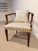 Front view of cane chair with striped cushion and pillow
