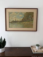 Full view of framed Monet print on wall above table