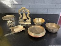 Group shot with bowls, dish, rhinoceros figurine, pedestal plate, hanging bell on stand