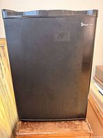 Front view of black Magic Chef mini fridge closed