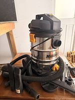 Full view of Mastercraft wet/dry vacuum with hose coiled around top