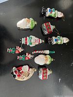 Group shot of all eleven glass ornaments on black surface