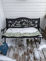 Front view of bench with cushion and snow