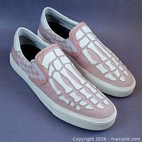Pair of pink AMIRI skeleton slip-on sneakers angled view