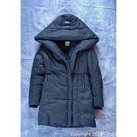 Full front view of green hooded puffer jacket