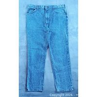 Full front view of stonewash blue Lee jeans laid flat