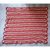 Full view of square crocheted blanket showing stripe pattern and wavy edges