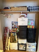 Overall closet view with wrapping paper, gift bags, storage towers and shelf items