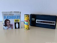 Front of Kodak Tele-Instamatic 608 camera, Sylvania Blue Dot AG1 flashbulbs box, Kodak film cartridge