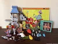 Overall view of lot showing puzzles, castle piece, figures and accessories