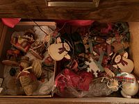 Drawer with assorted ornaments showing wooden snowmen and resin Thanksgiving pieces
