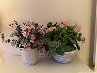 Both faux floral arrangements showing containers and flowers