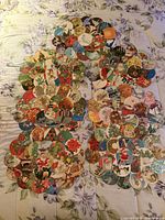 Full set of twelve handmade Christmas card placemats arranged on bed