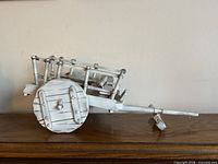 Right-side view of entire distressed white miniature cart