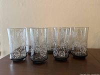 Six clear floral tumblers displayed on table