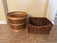 Round two-tone wicker basket and rectangular dark-brown wicker basket side by side on tile floor