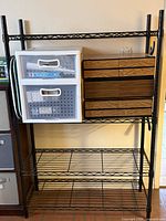 Full view of black metal wire shelving rack showing all shelves