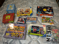 All ten boxed children’s puzzles laid out for overview