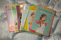 Front covers fanned to show artwork and confirm six different titles