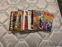 All eight Marvel compilation books fanned out on mattress