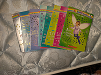 Front covers of all eight Rainbow Magic books fanned out