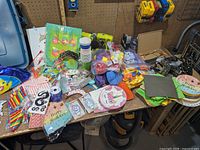 Wide view of all assorted party supplies on workbench