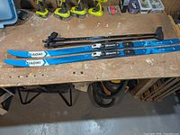 Overall view of skis and poles on workbench