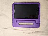 Front view of Samsung Galaxy Tab A tablet in purple case lying flat