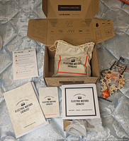 Open kit box showing canvas bag, instruction manuals, and packaging
