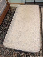 Top view of twin mattress showing quilted pattern and condition
