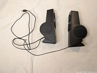 Top view of both speakers with connecting USB cable visible