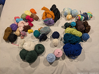 Entire collection of mixed yarn balls, skeins and roving laid out on surface