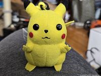 Front view of Pikachu plush keychain with clip and facial details