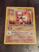 Front view of Magby Neo Genesis card showing artwork, text, and number 23/115