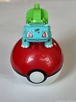 Bulbasaur figure assembled sitting on Poké Ball front view