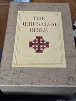 Tan slipcase front showing title and cross graphic