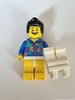 Front view of minifigure holding separate white legs