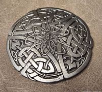 Front of round pewter brooch showing Celtic knot design