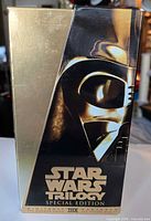 Front of gold slipcase showing Darth Vader artwork and Star Wars Trilogy Special Edition branding