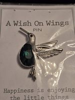 Front view of sealed hummingbird brooch on backing card