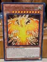 Front of The Winged Dragon of Ra – Immortal Phoenix card showing artwork and text